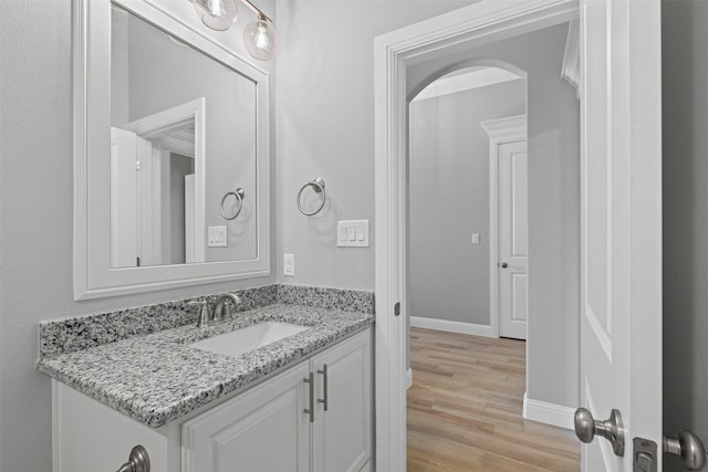 833 Haley, Springtown, TX 76082 - bathroom featuring vanity, wood finished floors, and baseboards