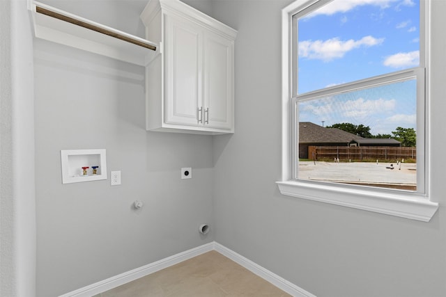 833 Haley, Springtown, TX 76082 - laundry area with electric dryer hookup, cabinet space, baseboards, hookup for a gas dryer, and plenty of natural light
