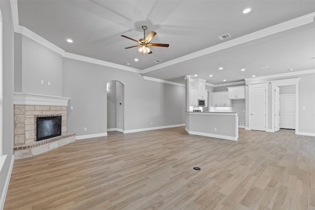 833 Haley, Springtown, TX 76082 - unfurnished living room with ceiling fan, arched walkways, light wood-style floors, baseboards, and recessed lighting