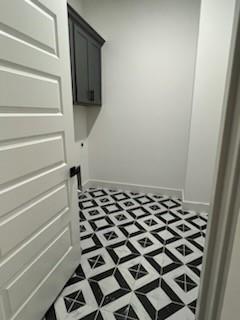 2076 Glenhollow Dr, Weatherford, TX 76088 - laundry room with cabinet space and baseboards
