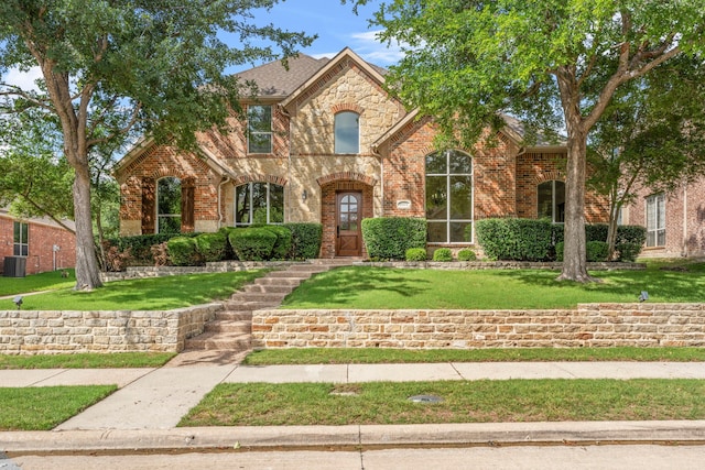 15372 Mountain View Ln, Frisco, TX 75035 - french country inspired facade with brick siding, a front lawn, stone siding, and roof with shingles