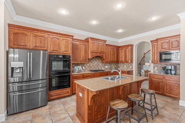 15372 Mountain View Ln, Frisco, TX 75035 - kitchen with stainless steel fridge, a sink, arched walkways, brown cabinets, and tasteful backsplash