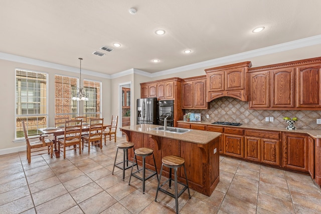 15372 Mountain View Ln, Frisco, TX 75035 - kitchen featuring stainless steel fridge, a sink, gas cooktop, tasteful backsplash, and a chandelier