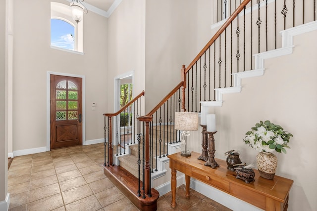 15372 Mountain View Ln, Frisco, TX 75035 - foyer featuring a towering ceiling, crown molding, baseboards, and stairs