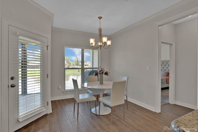 2087 Sand Crest Dr, Shreveport, LA 71118 - dining area featuring a chandelier, wood finished floors, baseboards, and crown molding