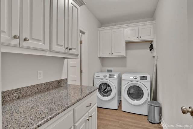 2087 Sand Crest Dr, Shreveport, LA 71118 - laundry room featuring cabinet space, washer and dryer, and light wood-style floors