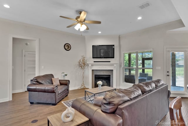 2087 Sand Crest Dr, Shreveport, LA 71118 - living room featuring ceiling fan, light wood-style floors, a glass covered fireplace, crown molding, and baseboards