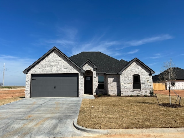 554 Calla Lily Dr, Tolar, TX 76476 - french country style house with an attached garage, driveway, brick siding, and stone siding