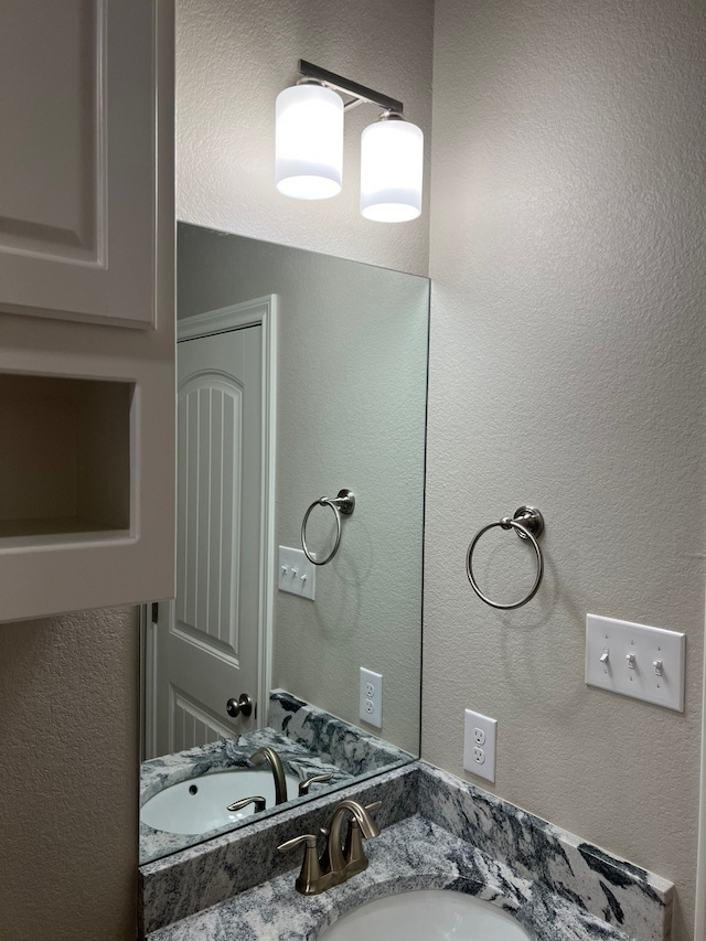 554 Calla Lily Dr, Tolar, TX 76476 - bathroom featuring vanity and a textured wall