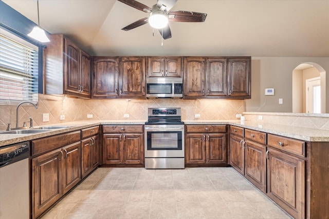 3007 Glenwood Ct, Aubrey, TX 76227 - kitchen featuring appliances with stainless steel finishes, a sink, arched walkways, ceiling fan, and light countertops
