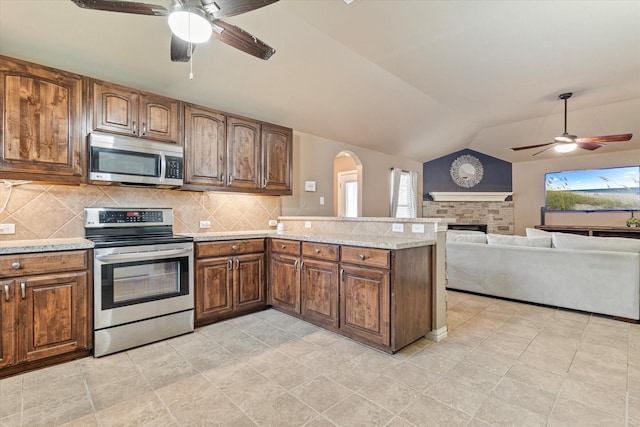 3007 Glenwood Ct, Aubrey, TX 76227 - kitchen with appliances with stainless steel finishes, a ceiling fan, healthy amount of natural light, and lofted ceiling