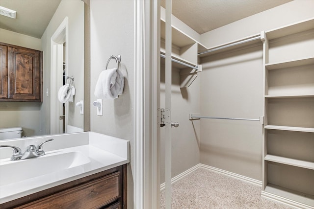 3007 Glenwood Ct, Aubrey, TX 76227 - bathroom with baseboards, vanity, toilet, and a spacious closet