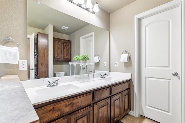 3007 Glenwood Ct, Aubrey, TX 76227 - bathroom with double vanity, toilet, and tile patterned floors