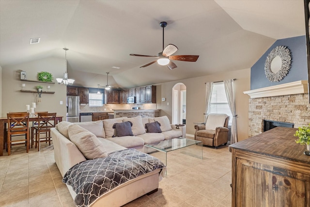 3007 Glenwood Ct, Aubrey, TX 76227 - living area with vaulted ceiling, a ceiling fan, light tile patterned floors, arched walkways, and a fireplace