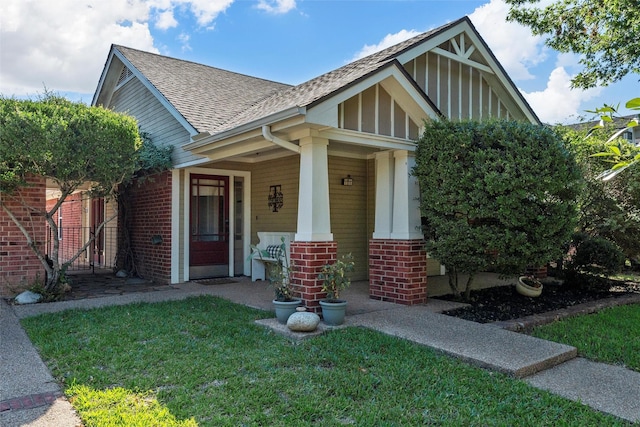 10513 Rayburn Way, Waco, TX 76708 - view of front of home with brick siding, roof with shingles, a front yard, and covered porch