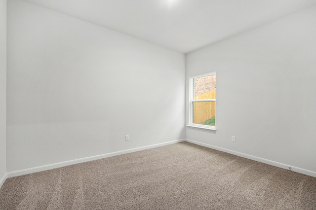 409 Gib Woodall Dr, Venus, TX 76084 - spare room with light colored carpet, baseboards, and vaulted ceiling