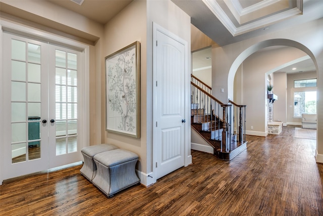 4540 Honeyvine Ln, Prosper, TX 75078 - entryway featuring french doors, dark wood-style flooring, arched walkways, ornamental molding, and stairway