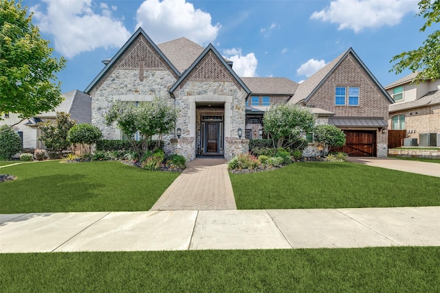4540 Honeyvine Ln, Prosper, TX 75078 - view of front of home with stone siding, a garage, concrete driveway, and a front yard