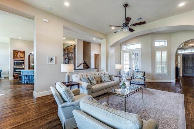 4540 Honeyvine Ln, Prosper, TX 75078 - living area featuring arched walkways, dark wood finished floors, stairway, baseboards, and recessed lighting