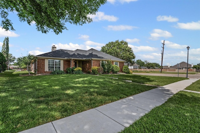 1501 Summerwind Ln, Lewisville, TX 75077 - view of front of house with a front lawn, brick siding, and a chimney