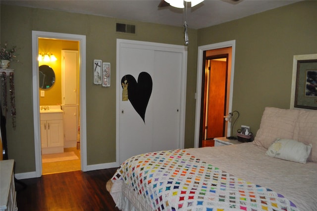 1405 Rolling Hills Dr, Graham, TX 76450 - bedroom featuring dark wood-type flooring, a closet, baseboards, and ensuite bath