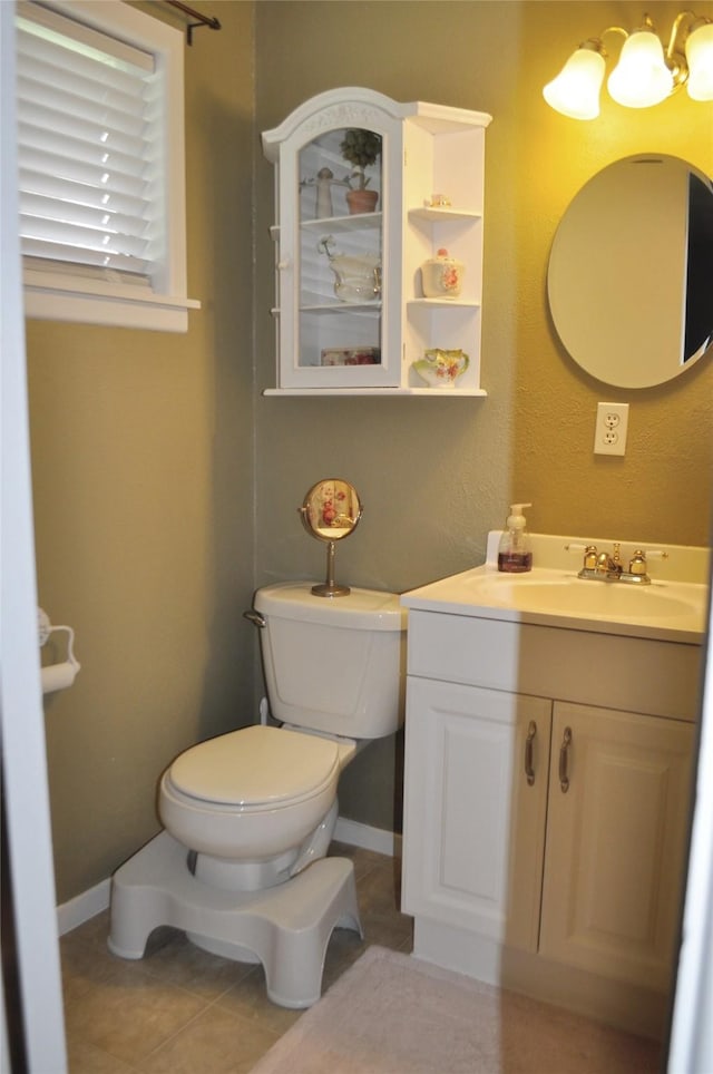 1405 Rolling Hills Dr, Graham, TX 76450 - half bath featuring vanity, toilet, baseboards, and tile patterned flooring