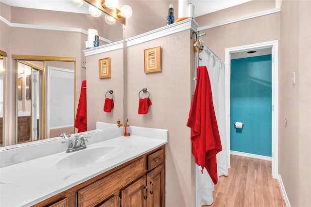 2135 Rose Cliff Ln, Carrollton, TX 75007 - full bath with vanity, wood finished floors, and baseboards