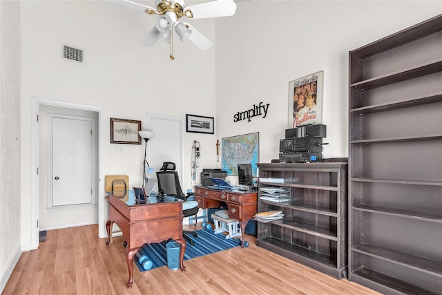 2135 Rose Cliff Ln, Carrollton, TX 75007 - office with a towering ceiling, a ceiling fan, wood finished floors, and baseboards