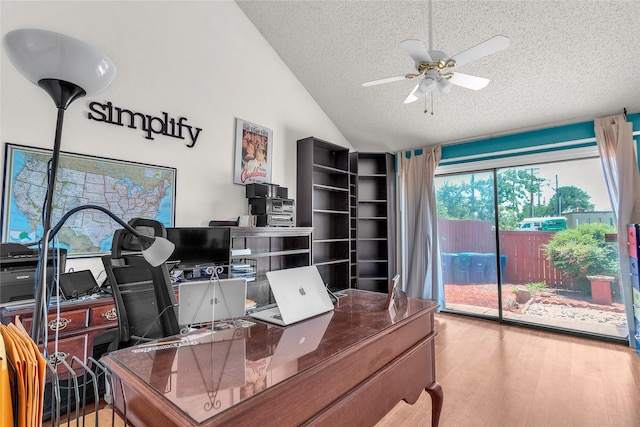 2135 Rose Cliff Ln, Carrollton, TX 75007 - home office with a textured ceiling, lofted ceiling, a ceiling fan, and wood finished floors