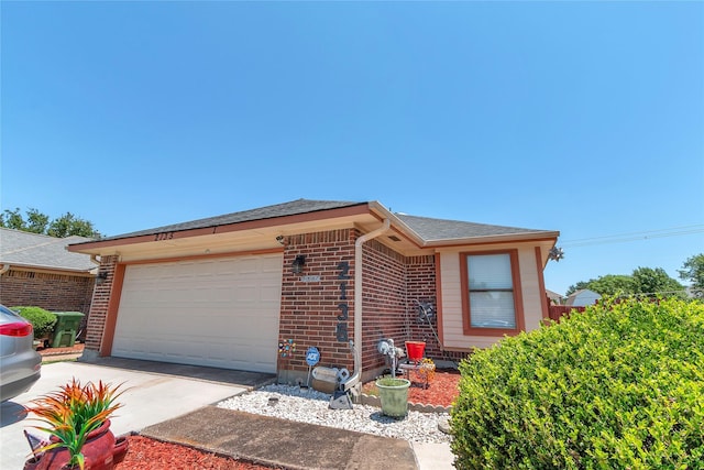 2135 Rose Cliff Ln, Carrollton, TX 75007 - single story home with brick siding, an attached garage, driveway, and a shingled roof