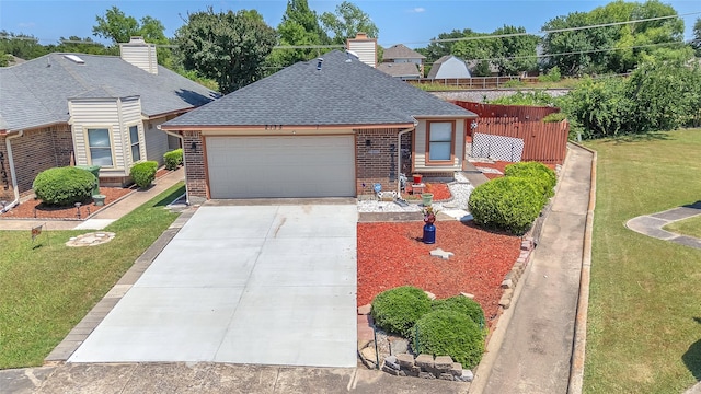 2135 Rose Cliff Ln, Carrollton, TX 75007 - view of front of home featuring brick siding, roof with shingles, a garage, a front yard, and driveway