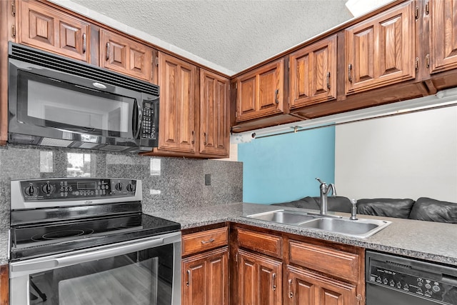 2135 Rose Cliff Ln, Carrollton, TX 75007 - kitchen with black appliances, a sink, brown cabinetry, decorative backsplash, and a textured ceiling