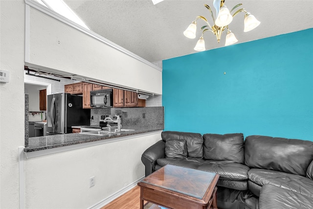 2135 Rose Cliff Ln, Carrollton, TX 75007 - living area featuring light wood finished floors and a textured ceiling