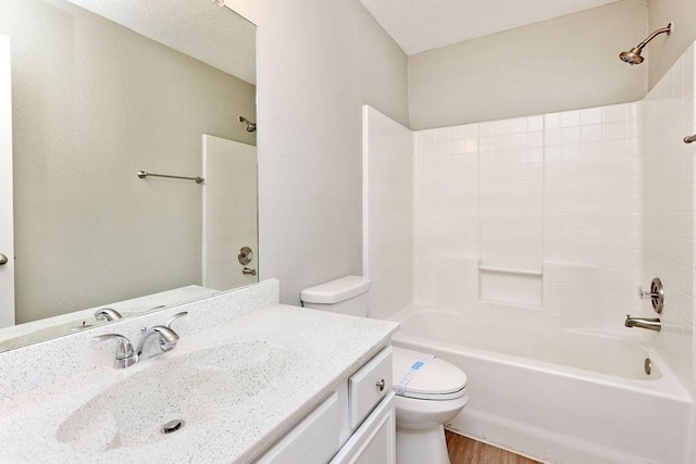 5907 Cohoke Dr, Arlington, TX 76018 - full bathroom with toilet, vanity, washtub / shower combination, and wood finished floors