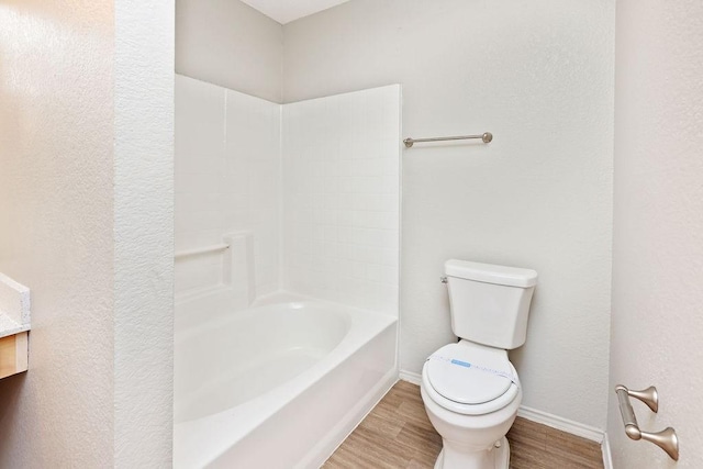 5907 Cohoke Dr, Arlington, TX 76018 - full bathroom with toilet, wood finished floors, baseboards, and  shower combination