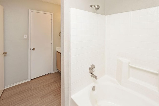 5907 Cohoke Dr, Arlington, TX 76018 - full bath featuring wood finished floors, washtub / shower combination, vanity, and baseboards
