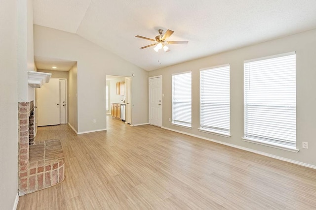 5907 Cohoke Dr, Arlington, TX 76018 - unfurnished living room with a ceiling fan, vaulted ceiling, baseboards, light wood finished floors, and a brick fireplace