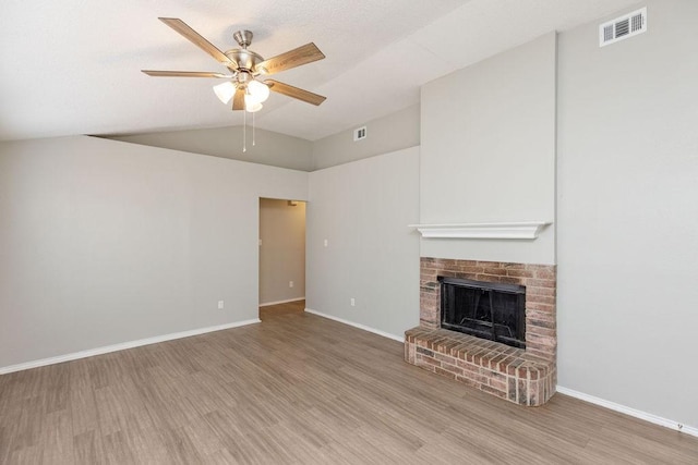 5907 Cohoke Dr, Arlington, TX 76018 - unfurnished living room featuring wood finished floors, a ceiling fan, lofted ceiling, a brick fireplace, and baseboards