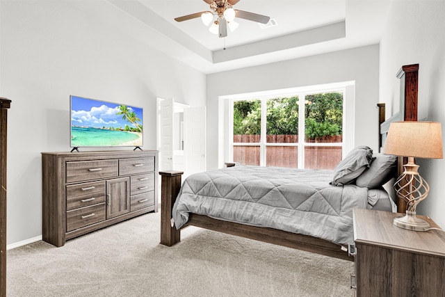 208 Rosemary Dr, Azle, TX 76020 - bedroom with light carpet, ceiling fan, a tray ceiling, and baseboards