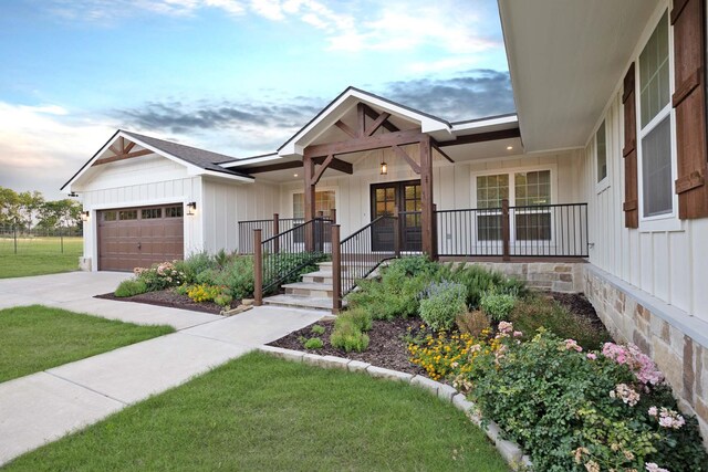 4107 Highland Rd, Melissa, TX 75454 - modern inspired farmhouse featuring a porch, board and batten siding, an attached garage, and driveway
