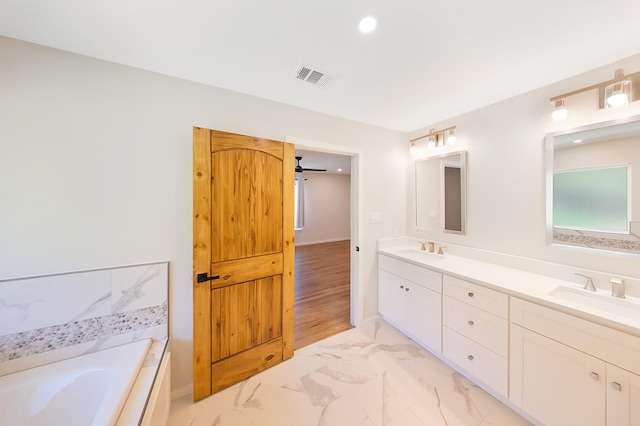 4107 Highland Rd, Melissa, TX 75454 - full bathroom with double vanity, a tub to relax in, marble look tile flooring, and recessed lighting