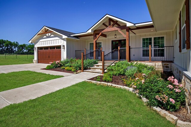 4107 Highland Rd, Melissa, TX 75454 - view of front of property with a front yard, an attached garage, driveway, a porch, and board and batten siding