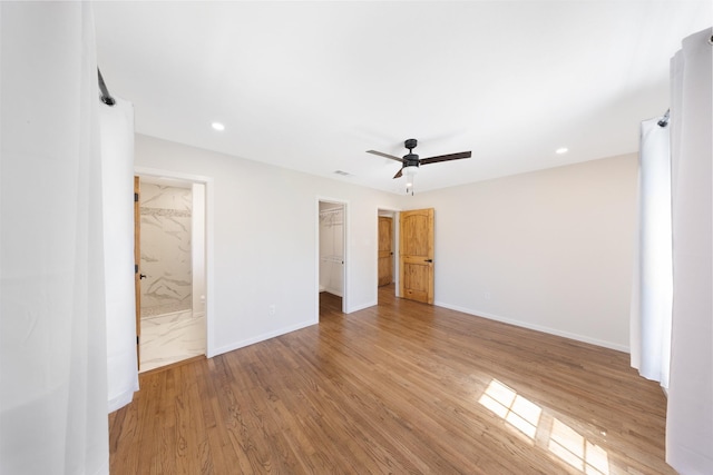 4107 Highland Rd, Melissa, TX 75454 - unfurnished bedroom with light wood finished floors, baseboards, a walk in closet, recessed lighting, and ensuite bathroom