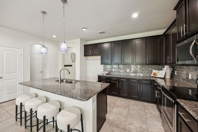 3740 Holly Brook Dr, Fort Worth, TX 76244 - kitchen with stainless steel appliances, a sink, dark stone counters, tasteful backsplash, and recessed lighting