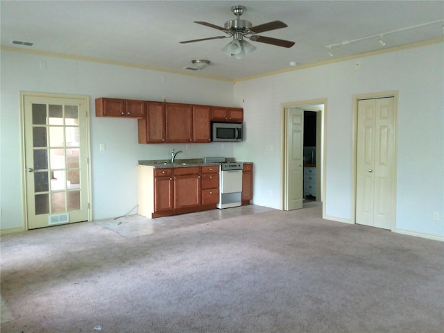 750 Ross Ave, Abilene, TX 79605 - kitchen with gas range gas stove, stainless steel microwave, light colored carpet, a ceiling fan, and a sink