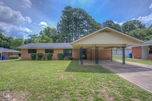808 E St, Minden, LA 71055 - ranch-style home with brick siding, a front lawn, driveway, and an attached carport
