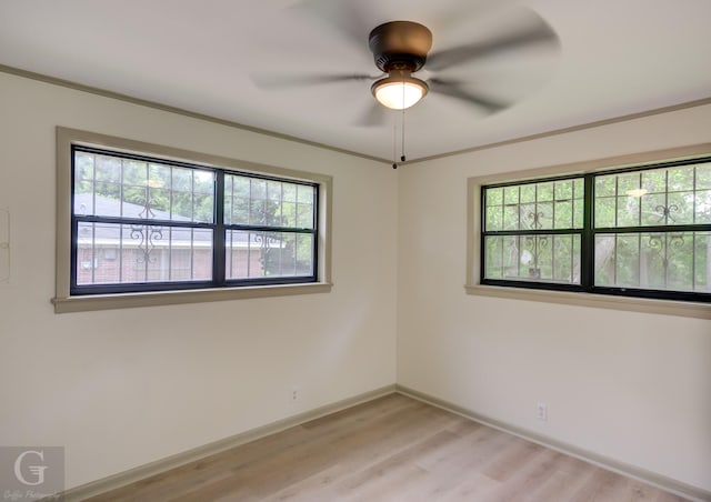 808 E St, Minden, LA 71055 - spare room featuring healthy amount of natural light, light wood finished floors, ceiling fan, and baseboards