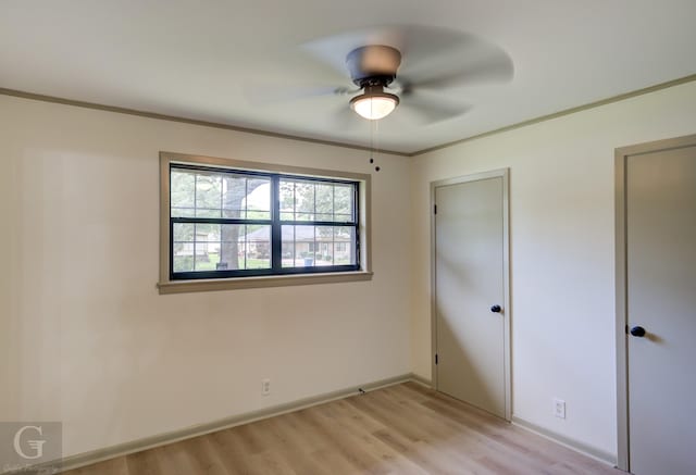808 E St, Minden, LA 71055 - unfurnished bedroom featuring light wood-style floors, baseboards, ornamental molding, and ceiling fan