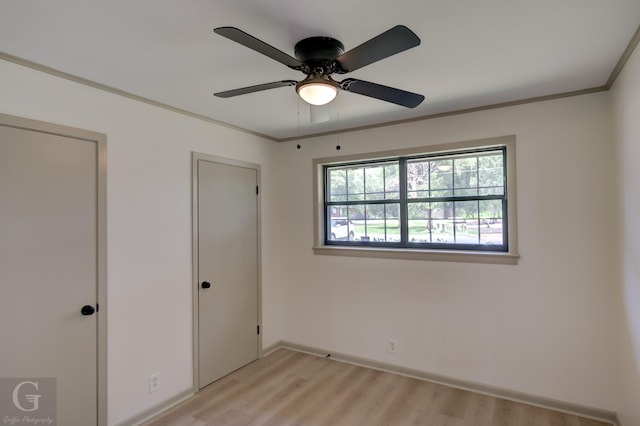 808 E St, Minden, LA 71055 - unfurnished bedroom with light wood-type flooring, baseboards, crown molding, and a ceiling fan