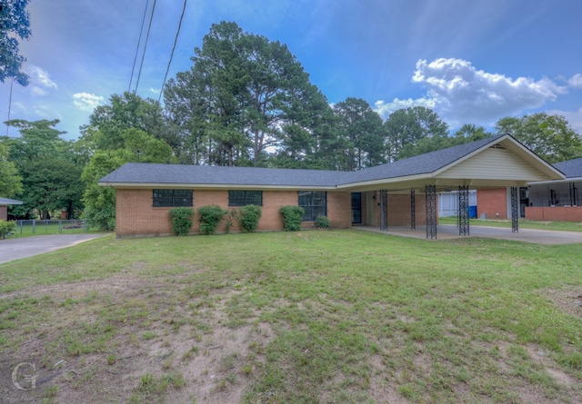 808 E St, Minden, LA 71055 - ranch-style home with brick siding, an attached carport, driveway, and roof with shingles
